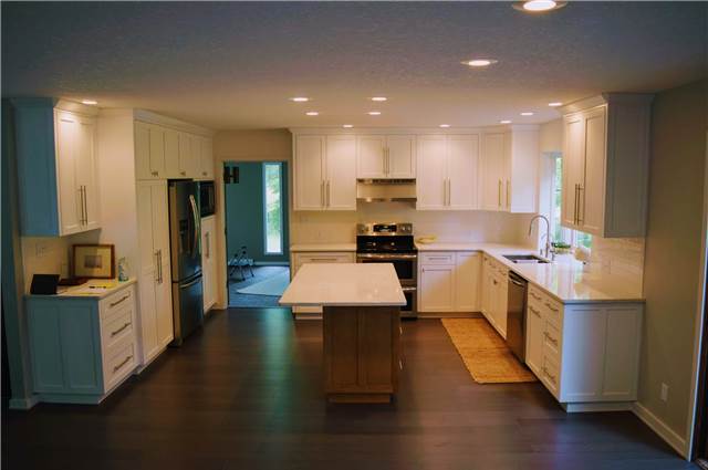 Painted perimeter cabinets - Stained maple island - Quartz countertops